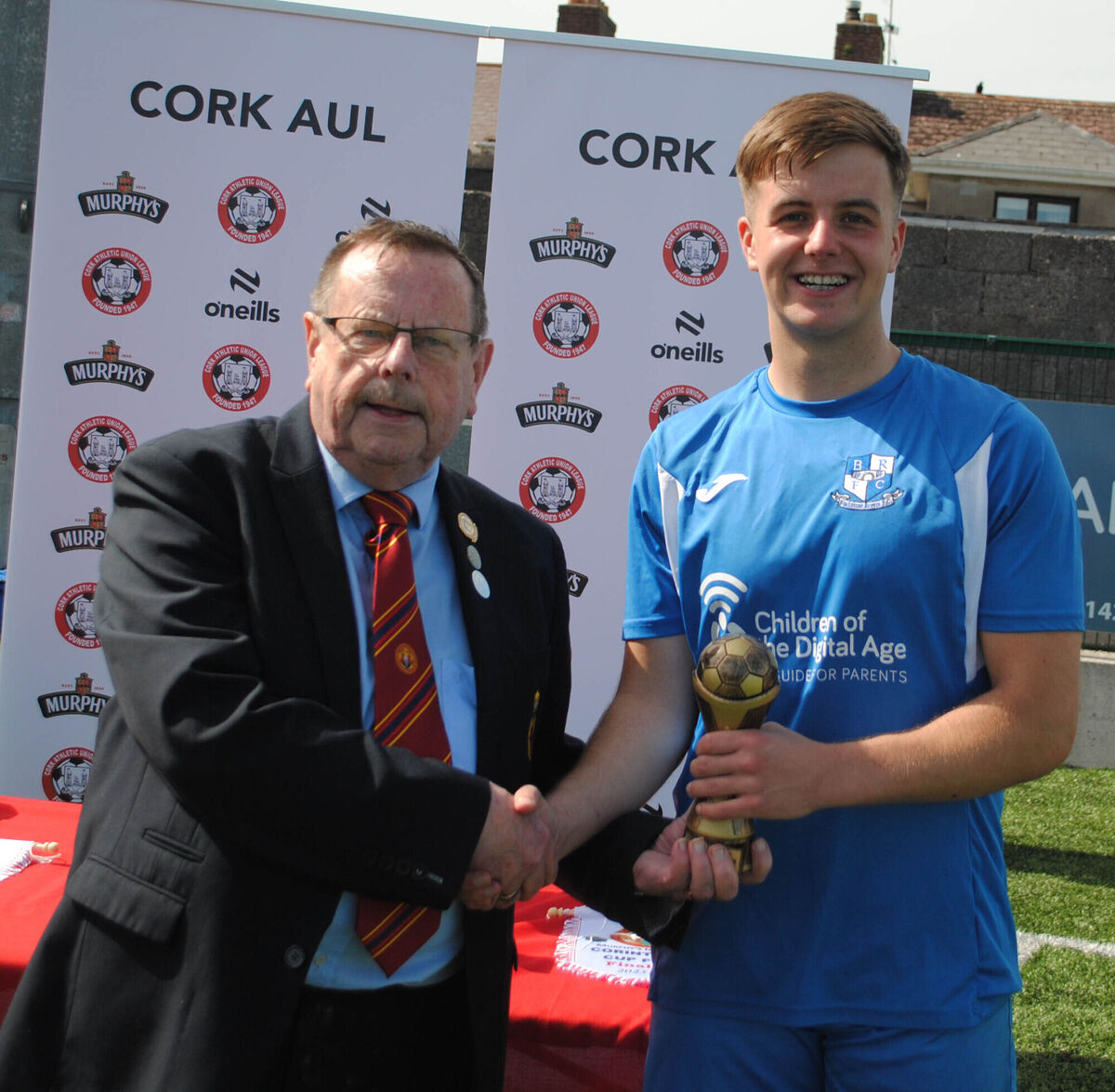 Tom Fitzgerald (Cork AUL) presents the man of the match award (Sponsored by Gary McCarthy Trophies) to Blackstone Rovers' Paddy Walsh. Tom Fitzgerald (Cork AUL) presents the man of the match award (Sponsored by Gary McCarthy Trophies) to Blackstone Rovers' Paddy Walsh.