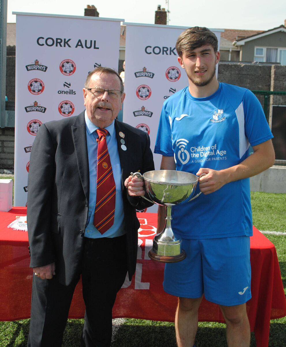 Tom Fitzgerald (Cork AUL) presents the Corinthian's Cup to Blackstone Rovers captain Sean Daly. Tom Fitzgerald (Cork AUL) presents the Corinthian's Cup to Blackstone Rovers captain Sean Daly.