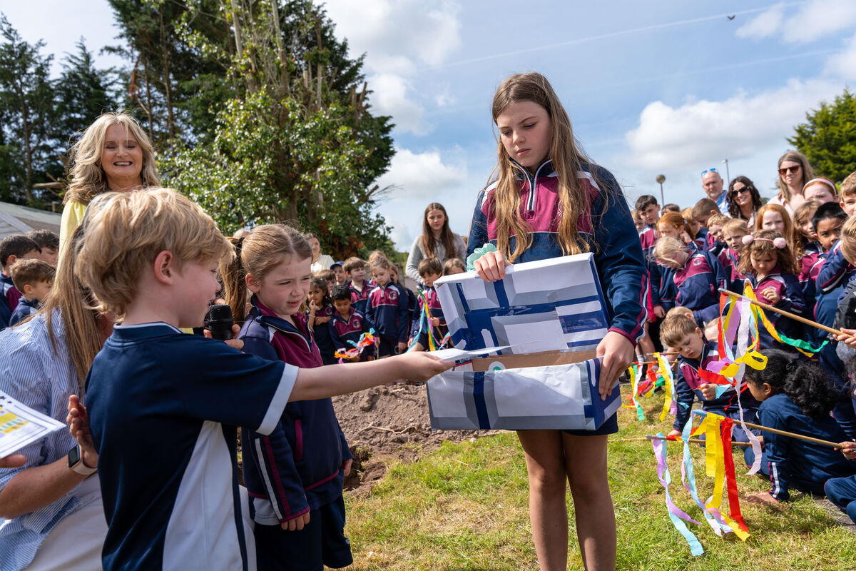 Pupils Jackson Byrne and Hannah Moynihan placed momentos in a time capsule held open by Grace Harris. Pupils Jackson Byrne and Hannah Moynihan placed momentos in a time capsule held open by Grace Harris.