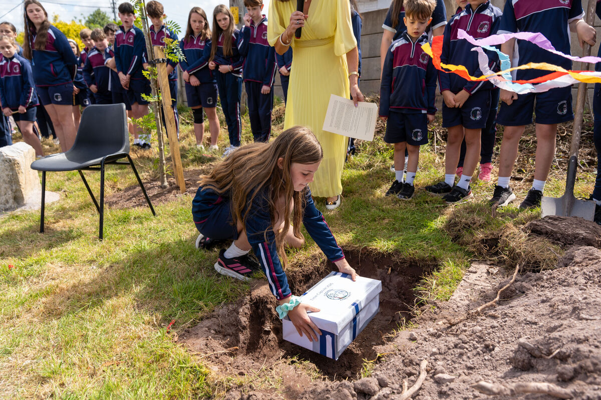 Grace Harris placing a time capsule to be buried. Grace Harris placing a time capsule to be buried.