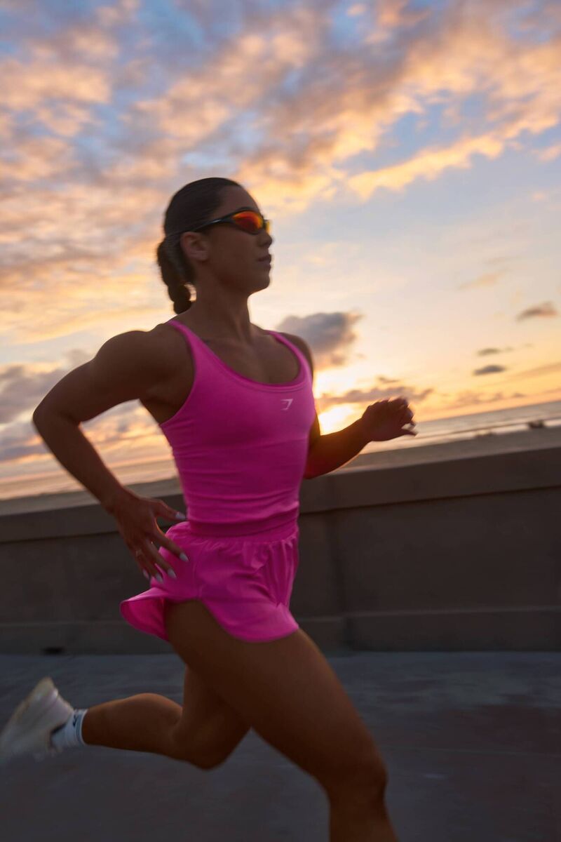 Model is wearing Gymshark Flutter Woven Shorts in Electric Pink and Interval Seamless Midi Tank in Electric Pink, Picture: Gymshark/PA Model is wearing Gymshark Flutter Woven Shorts in Electric Pink and Interval Seamless Midi Tank in Electric Pink, Picture: Gymshark/PA