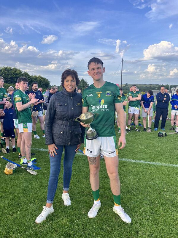 Avril Geary, Chairperson East Cork GAA presents the trophy to Cobh's Conor McLaughlin. Avril Geary, Chairperson East Cork GAA presents the trophy to Cobh's Conor McLaughlin.