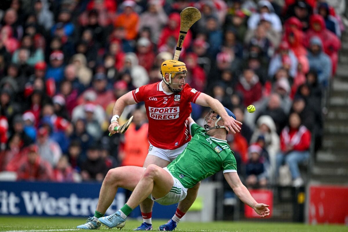 Shane O’Brien of Limerick falls while under pressure from Niall O'Leary of Cork. Picture: Ray McManus/Sportsfile