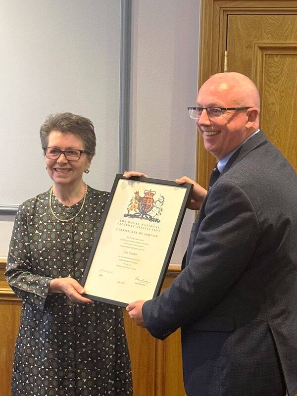 RNLI chairperson Janet Legrand presents Ian Venner with an award for service to the RNLI. Picture: RNLI.