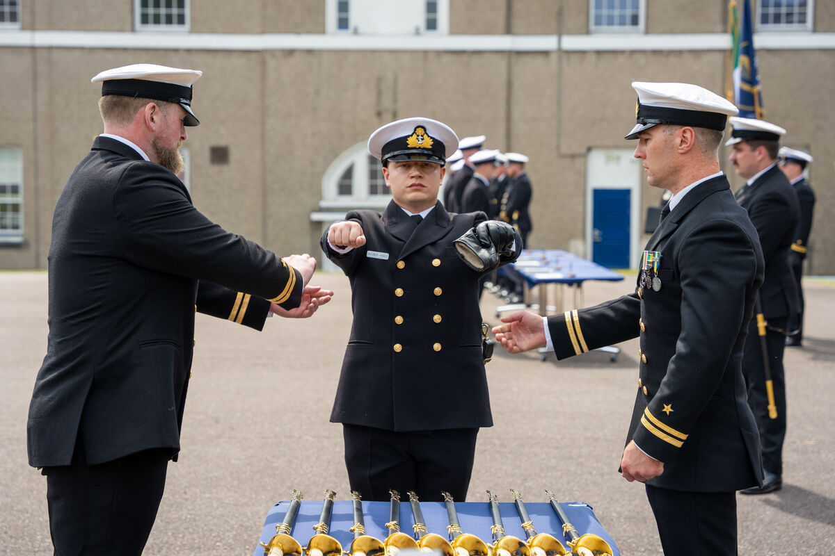 Cadet of the year, Aidan Dean Webber-Hobbs has his golden stripes unveiled during the Naval Graduation ceremony. Cadet of the year, Aidan Dean Webber-Hobbs has his golden stripes unveiled during the Naval Graduation ceremony.
