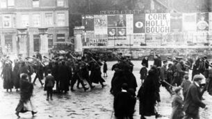 <p>A poster advertising sales of the Holly Bough is seen in the background of this picture taken during World War I. </p>