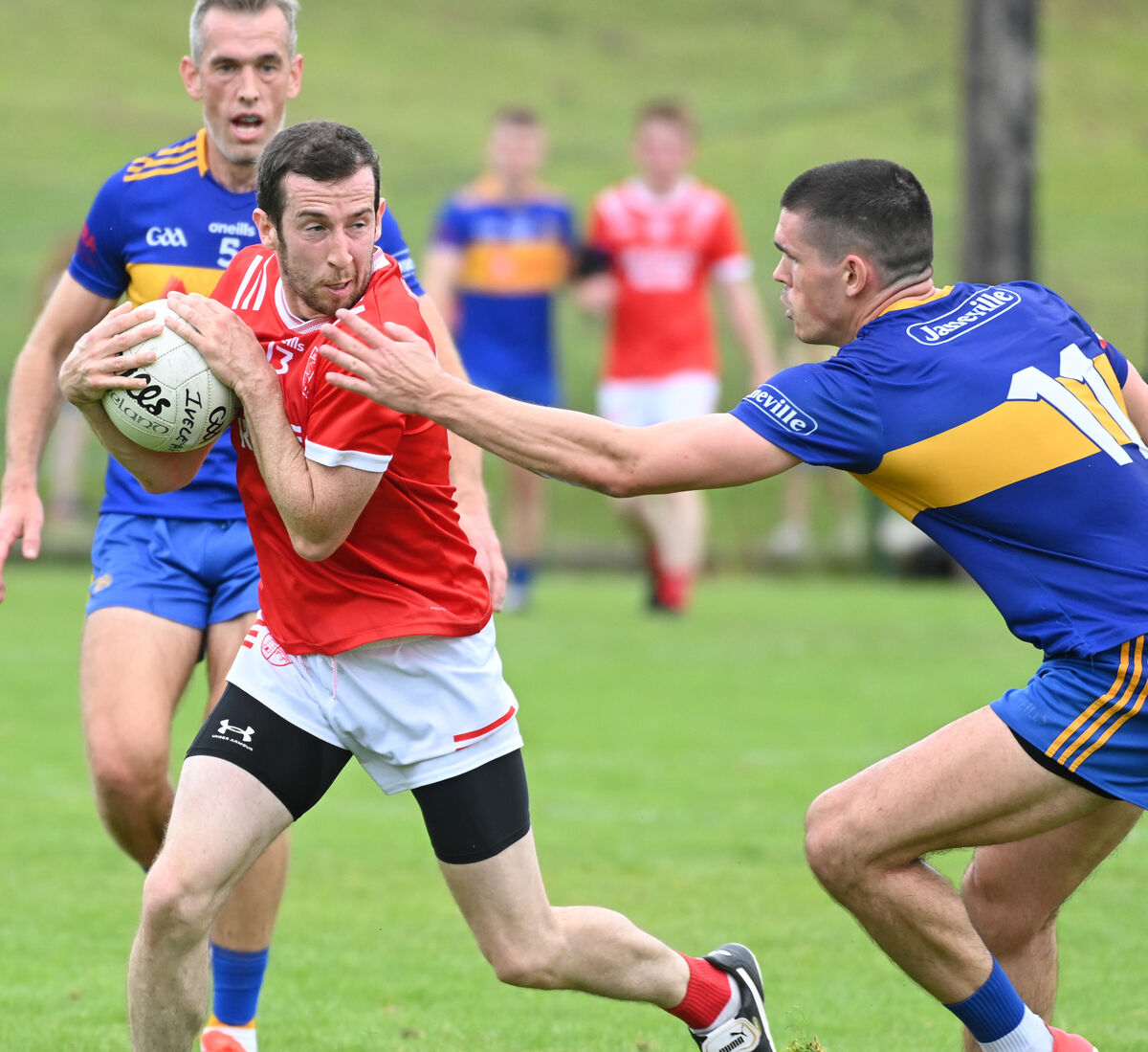 Uibh Laoire's Sean O'Leary is tackled by Carrigaline's Dave Griffin. Picture: Eddie O'Hare