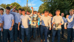 <p>Captain Joe Miskella and Tom Whooley carry the All-Ireland cup at their homecoming for the Cork minor footballers at Ballincollig GAA after they defeated Tyrone in the All-Ireland final. Picture: David Creedon</p>