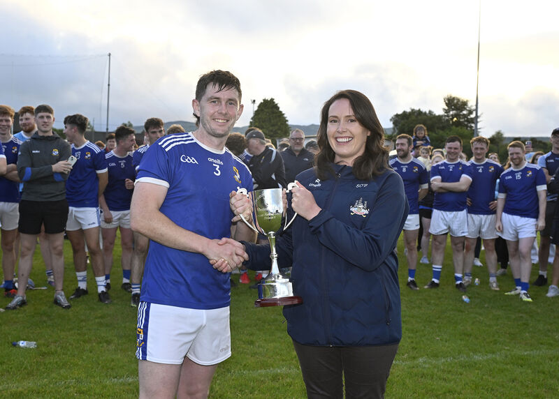 Susan O'Brien, Planning and Training Officer of Cork GAA, presents the cup to Aghinagh captain Donagh O'Riordan after winning the Division 6 Football League title. Picture: Martin Walsh Susan O'Brien, Planning and Training Officer of Cork GAA, presents the cup to Aghinagh captain Donagh O'Riordan after winning the Division 6 Football League title. Picture: Martin Walsh