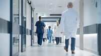 Hospital Hallway with Doctors, Nurses and Specialists in Hospital. Female and Male Physicians, Surgeons, Healthcare Officials Wa