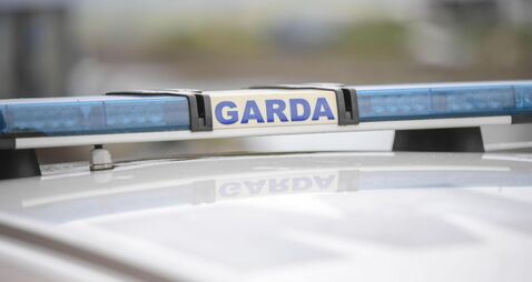 Garda sign and blue lights on a Garda car.