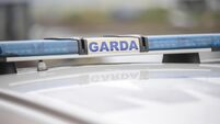 Garda sign and blue lights on a Garda car.