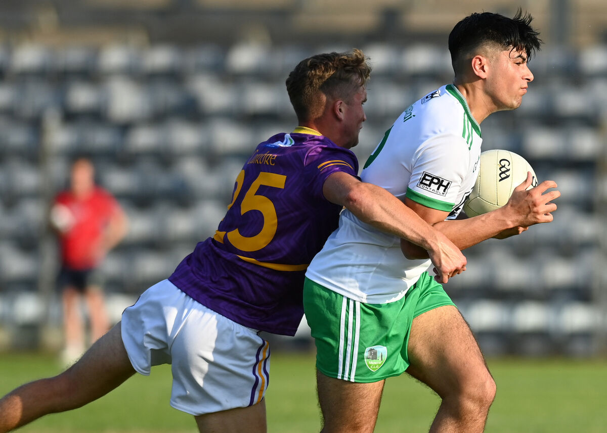 Muskerry's Ryan Sabas clutches the ball as Keith O'Driscoll of Carbery closes in. Picture: Martin Walsh Muskerry's Ryan Sabas clutches the ball as Keith O'Driscoll of Carbery closes in. Picture: Martin Walsh