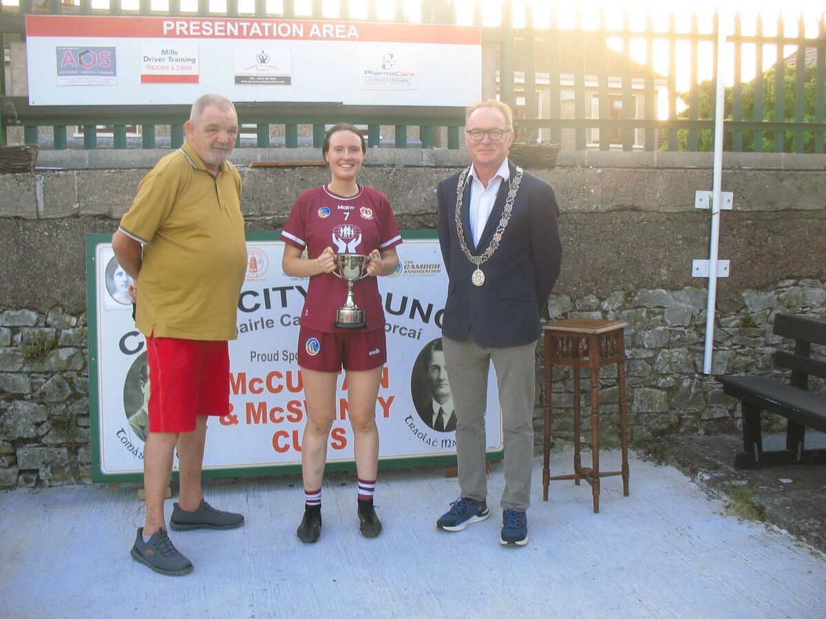 Bishopstown winning captain Aifirc Walsh with the Muirgheal MacSwiney Cup, flanked by Seandún Chairman Mick Buckley and Des Cahill representing the Lord Mayor, at Ballinlough.
