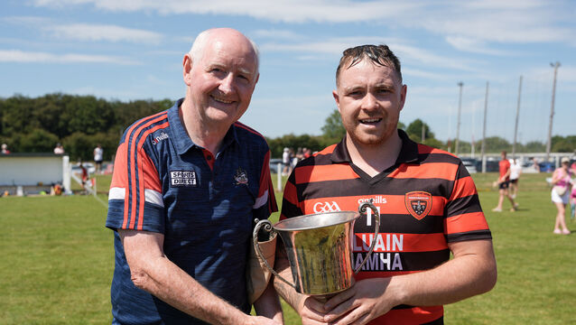 <p>Brian O’Shea, Cloyne captain, is presented with the cup by Pat Horgan, chairman of Cork GAA. Picture: Noel Sweeney</p>