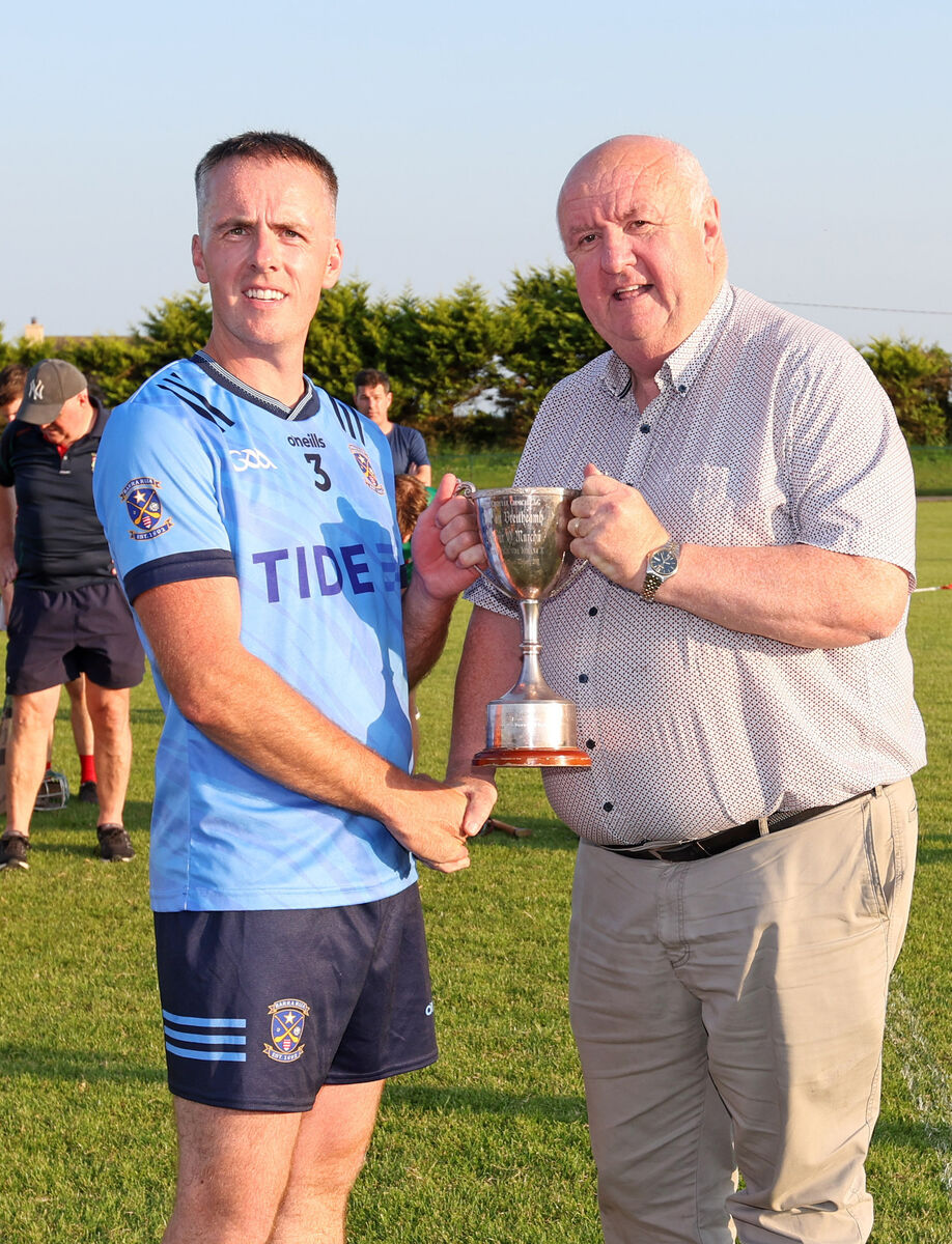 Barryroe captain Jerome O'Brien receives the cup from Cork County Board vice-chairperson Noel O'Callaghan. Picture: Jim Coughlan