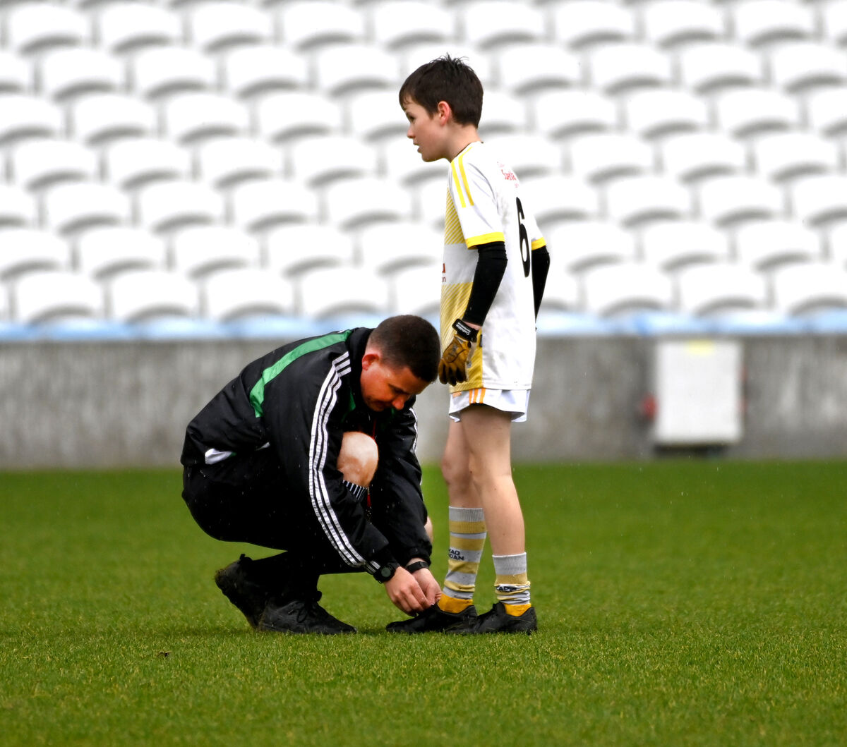 Colm Lyons ties the boot laces of Crossmahon NS's Seán Prendergast during the Allianz Sciath na Scol DF4 final at Páirc Uí Chaoimh in 2023. Picture: Eddie O'Hare Colm Lyons ties the boot laces of Crossmahon NS's Seán Prendergast during the Allianz Sciath na Scol DF4 final at Páirc Uí Chaoimh in 2023. Picture: Eddie O'Hare