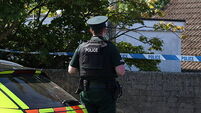 Police remain at the scene after three relatives found dead in family home