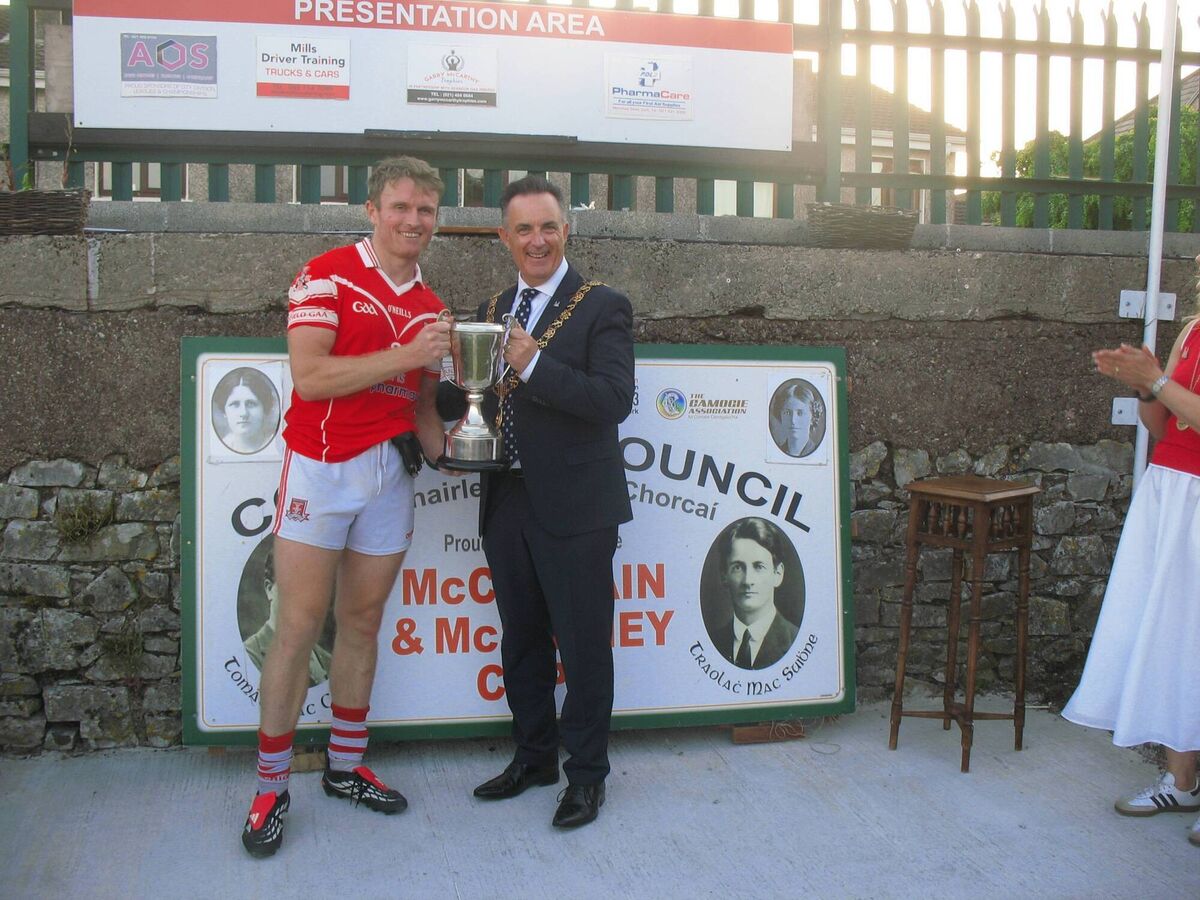Lord Mayor of Cork Cllr Damien Boylan presents the MacSwiney Cup to Mayfield winning captain Shane O'Donovan