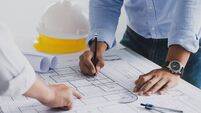 engineer meeting for an architectural project. working with partner and engineering tools working on blueprint architectural pro