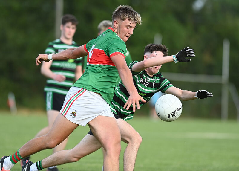 Clon's Ewan Knowles gets his shot away despite the efforts of Tomás Reddington. Picture: Martin Walsh Clon's Ewan Knowles gets his shot away despite the efforts of Tomás Reddington. Picture: Martin Walsh