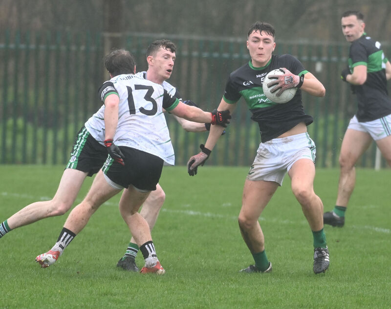 Nemo Rangers' Colin Molloy turns inside Douglas' Alan O'Hare and Adam Cantwell. Picture: Eddie O'Hare Nemo Rangers' Colin Molloy turns inside Douglas' Alan O'Hare and Adam Cantwell. Picture: Eddie O'Hare