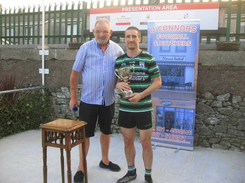 Seandún Chairman Mick Buckley presents the Seandún Cup to Douglas winning captain Kevin Murphy Seandún Chairman Mick Buckley presents the Seandún Cup to Douglas winning captain Kevin Murphy