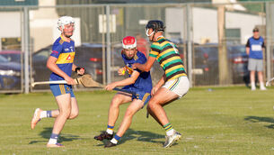 <p>Carrigaline's Cillian Buckley tries to get past the Glen's Michael Brosnan. Picture: David Creedon</p>