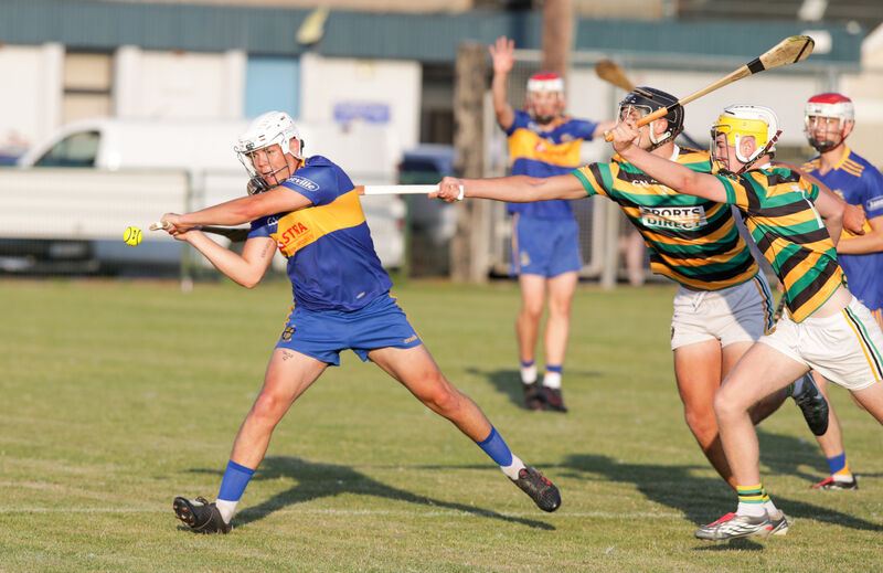 Carrigaline's Ollie Lynch drives the ball downfield as he is tackled by the Glen's Conor Burke. Picture: David Creedon