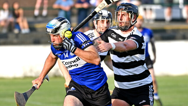 <p>BUSY: Sarsfields' Cian McCarthy is tackled by Midleton's Killian Burke during the RedFM HL Division 1 game at Midleton. Picture: Eddie O'Hare</p>