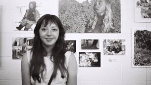 <p>Cork artist Odessa Yip in front of some of her work</p>
