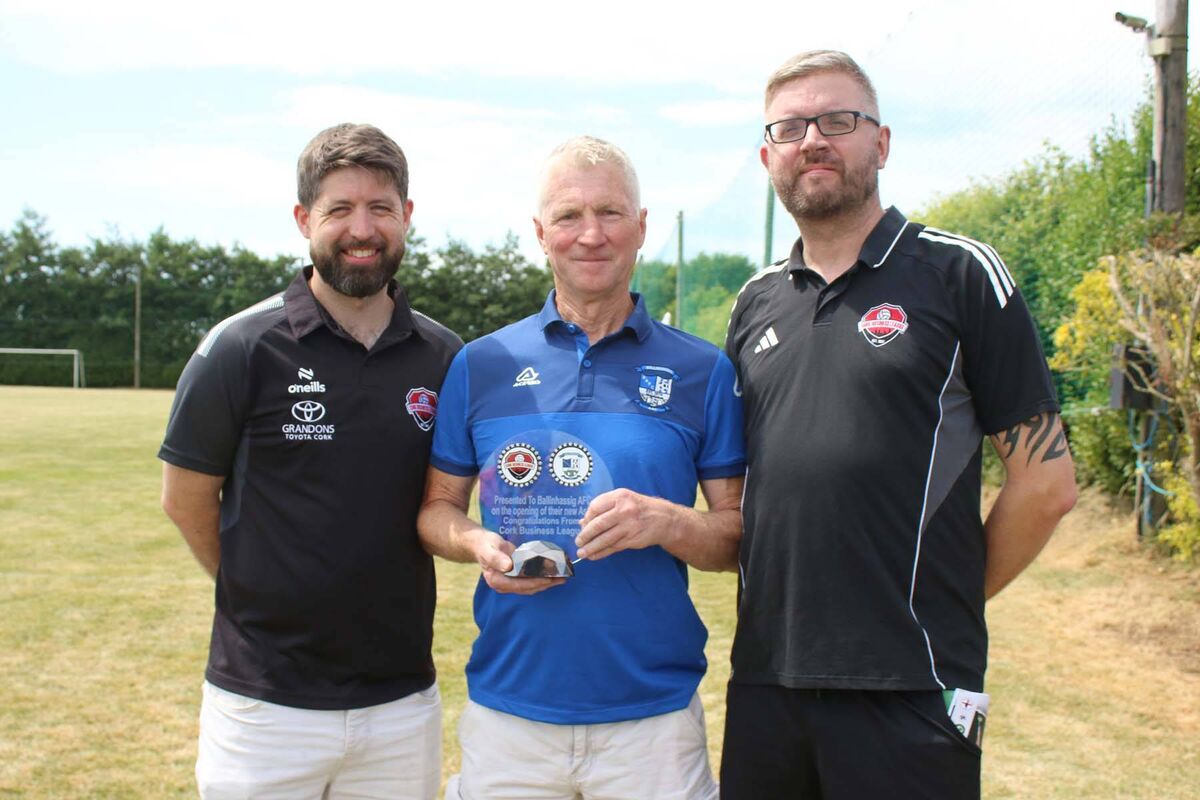 Peter Travers and Anthony Golden of the Cork Business League make a presentation to Ballinhassig AFC chairman Gerard Spillane at the opening of the club's new all-weather pitch. 