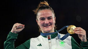 Kellie Harrington celebrates with her gold medal on the podium 6/8/2024