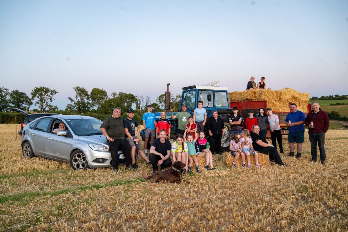 Volunteers, neighbours, friends and family gather for a group photograph after helping bring in the small hay bales during the annual community haymaking evening at Dennis Hickey’s farm near Midleton, Co Cork. Picture: Chani Anderson Volunteers, neighbours, friends and family gather for a group photograph after helping bring in the small hay bales during the annual community haymaking evening at Dennis Hickey’s farm near Midleton, Co Cork. Picture: Chani Anderson