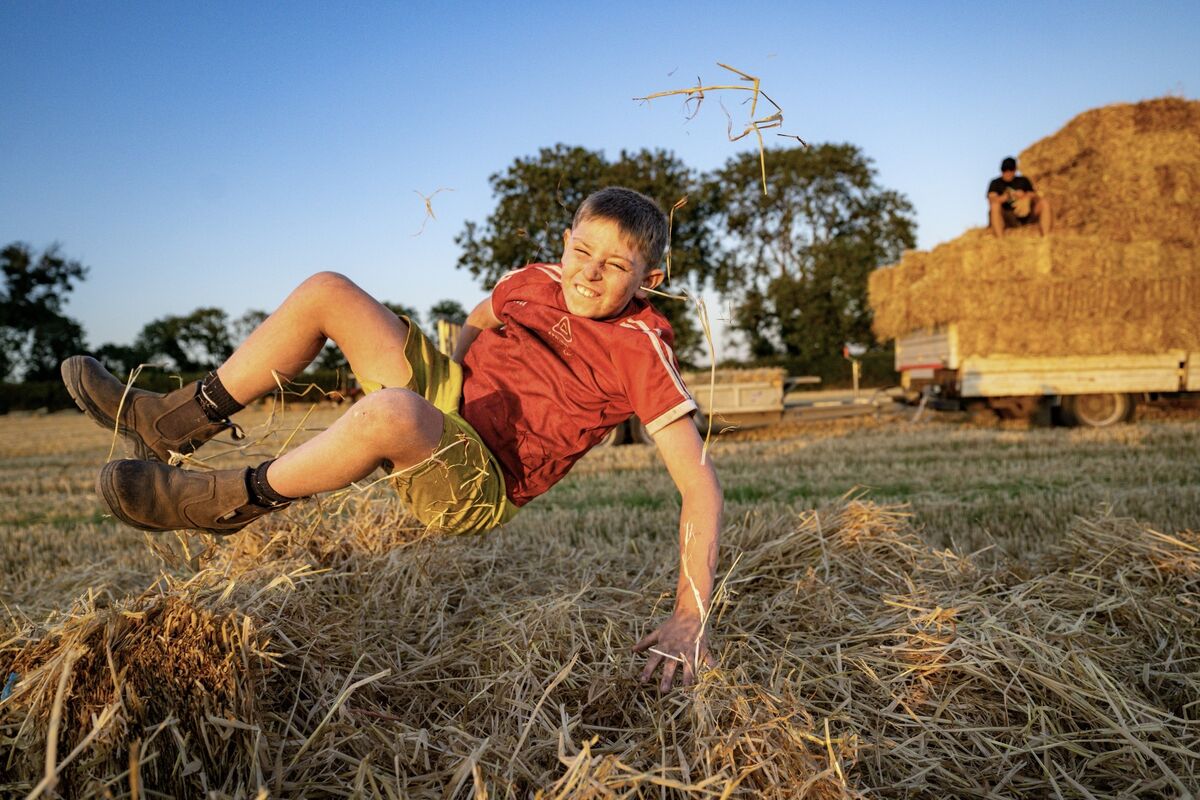 Jack Dillon launches himself into a stack of freshly made hay bales after an evening of hard work during the annual community haymaking event at Dennis Hickey’s farm near Midleton, Co Cork. Picture: Chani Anderson Jack Dillon launches himself into a stack of freshly made hay bales after an evening of hard work during the annual community haymaking event at Dennis Hickey’s farm near Midleton, Co Cork. Picture: Chani Anderson