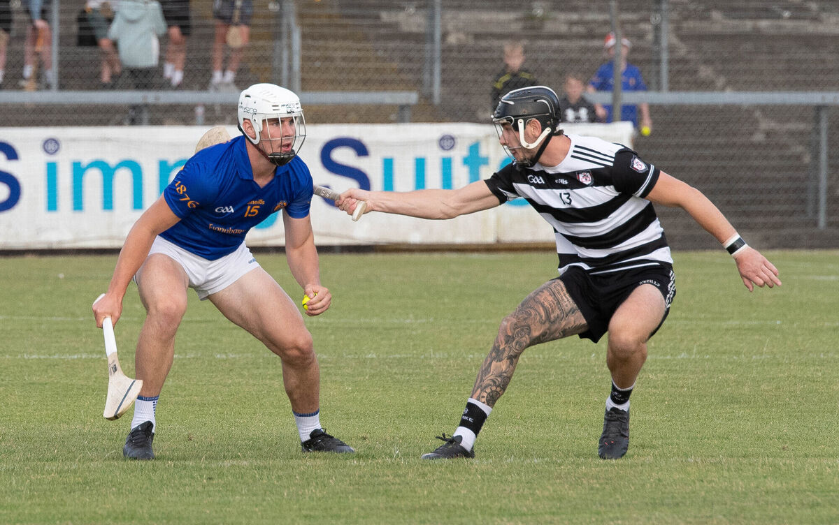 Ross O'Regan of Midleton looks to challenge Rickey Barrett of St Finbarr's. Picture: Howard Crowdy