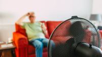Senior man keeping cool at home during summer heat wave