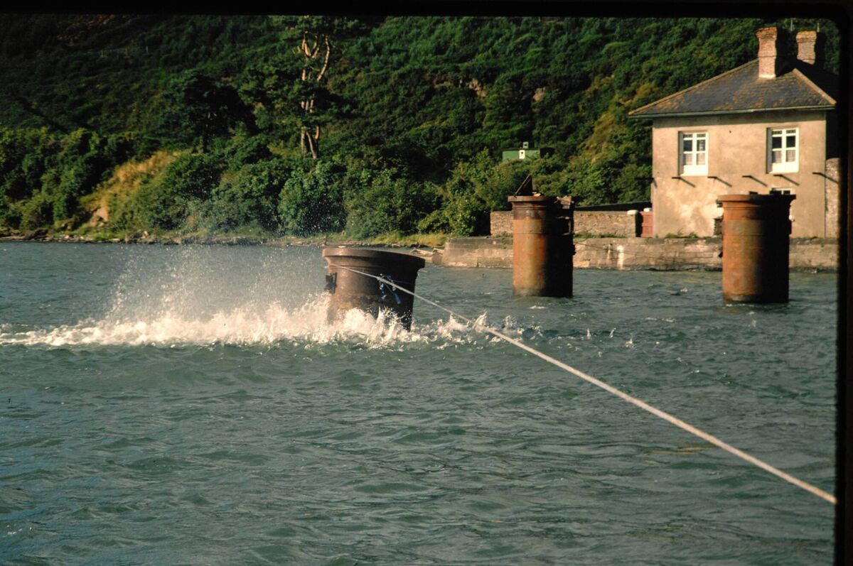 Piers being pulled over to lie flat on the river bed during the demolition of the old bridge at Youghal Piers being pulled over to lie flat on the river bed during the demolition of the old bridge at Youghal