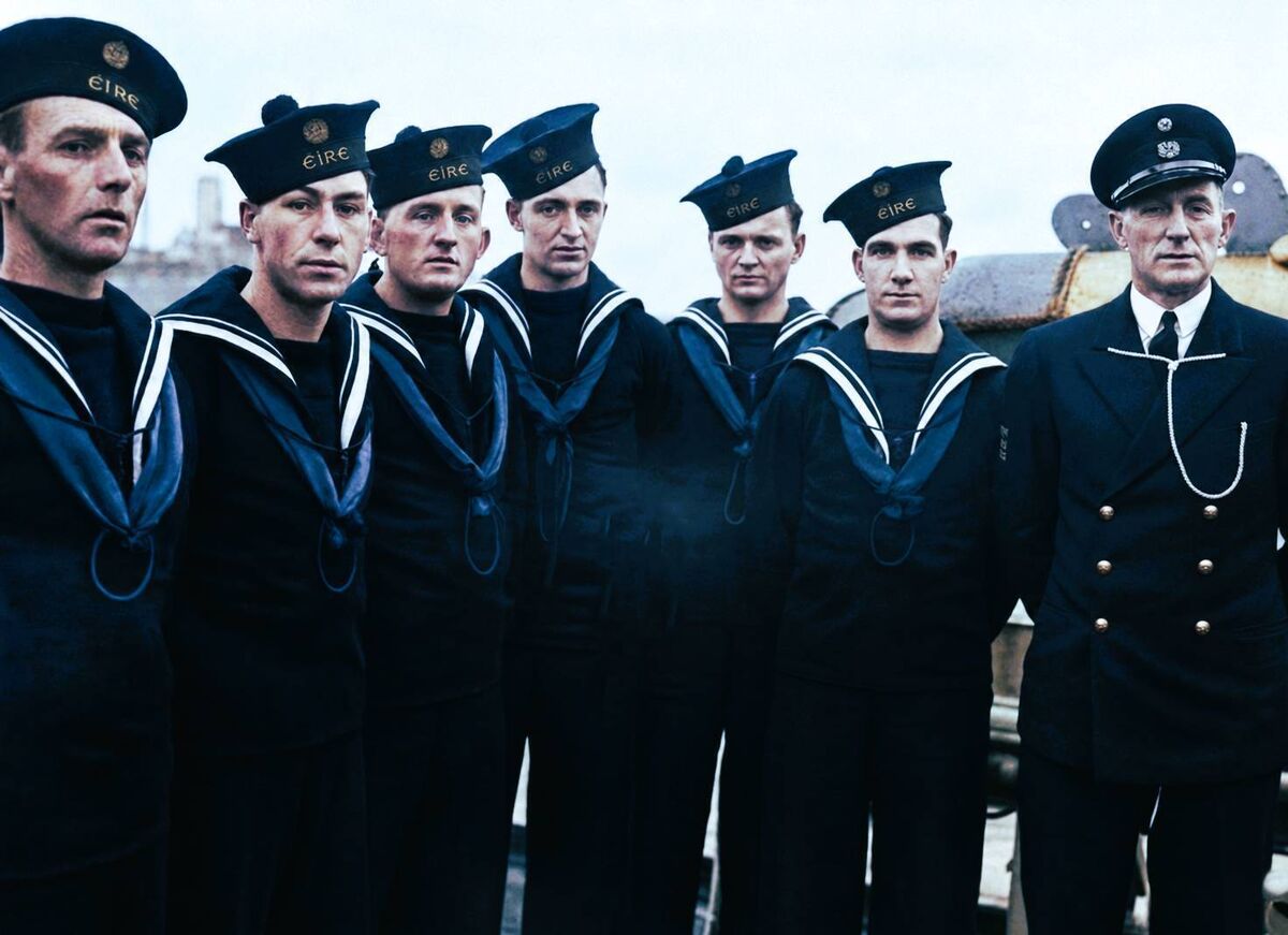 The commissioning ceremony for the LE Macha in England on November 15, 1946, with Capt Henry Jerome, OC Naval Service (right), Lt Walter Reidy (second left), and Irish High Commissioner John Dulanty, pictured with Royal Navy officers and clergymen