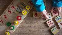 Child playing with mathematical toy