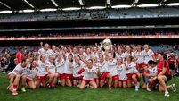 The Cork team celebrate with the O'Duffy Cup after the match 9/8/2026