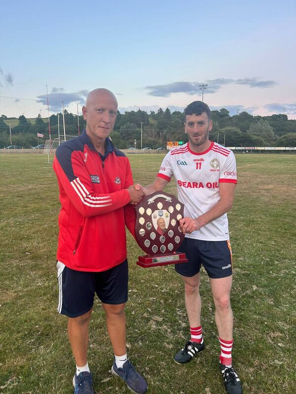 Adrigole GAA chairman Fergus Carey presents the trophy to Urhan captain Michael O'Shea. Adrigole GAA chairman Fergus Carey presents the trophy to Urhan captain Michael O'Shea.