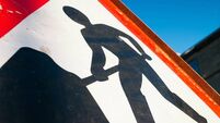 Men At Work sign closeup