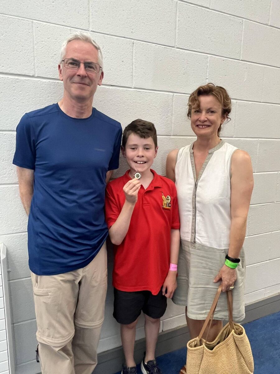 John Woods, Comhaltas na Dúglaise, who was placed third in the whistling U12 competition at the Munster Fleadh Cheoil in Lismore recently, with his parents. John is a pupil of Gaelscoil na Dúglaise. 