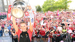 <p>Cork All-Ireland winning camogie captain Meabh Cahalane raises the O'Duffy Cup at the homecoming on the Grand Parade. Picture: Eddie O'Hare</p>