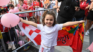 <p>Cork supporter Sophia O'Shea welcomes home the All-Ireland camogie-winning team at the homecoming in Cork. Picture: Eddie O'Hare</p>