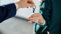 Close-up of a couple receiving key of their new real estate.