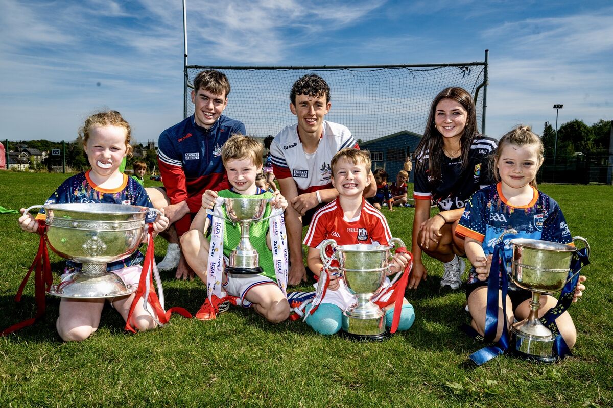 Orla O’ Leary, Joe McLaughlin, Archie O’Sullivan and Sarah O’Regan at Bandon GAA Cúl Camp with Cork minor football stars Evelyn McCarthy, Rory Twohig and Donncha O’Mahony and the All Ireland silverware they helped bring home this year. Pictures: Chani Anderson