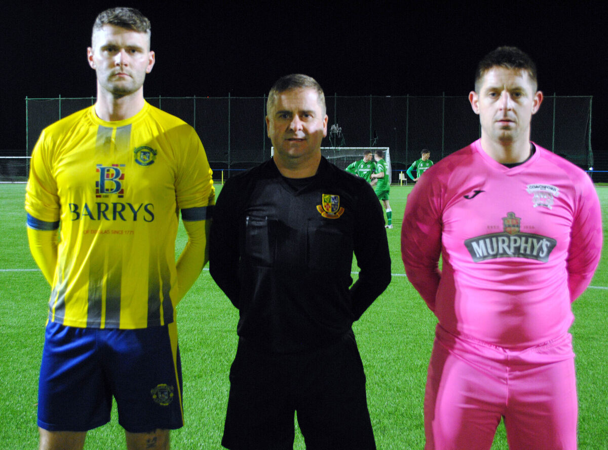Douglas Hall captain Luke Mullins O'Keeffe (left) with Coachford's Stephen Murray, accompanied by referee Allan Martin.