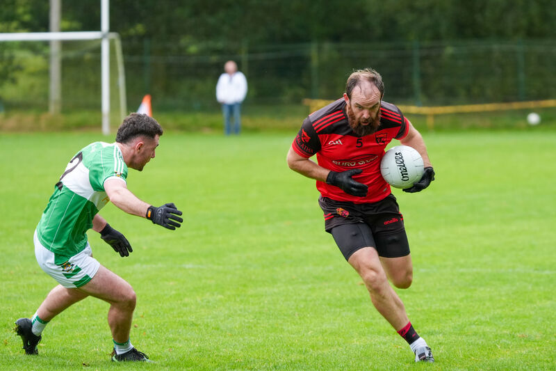 Ballingeary’s Cian Ó Duinnín avoids the challenge of Aghabullogue’s Paul Dilworth during their SAFC clash at Macroom. Picture: Noel Sweeney Ballingeary’s Cian Ó Duinnín avoids the challenge of Aghabullogue’s Paul Dilworth during their SAFC clash at Macroom. Picture: Noel Sweeney